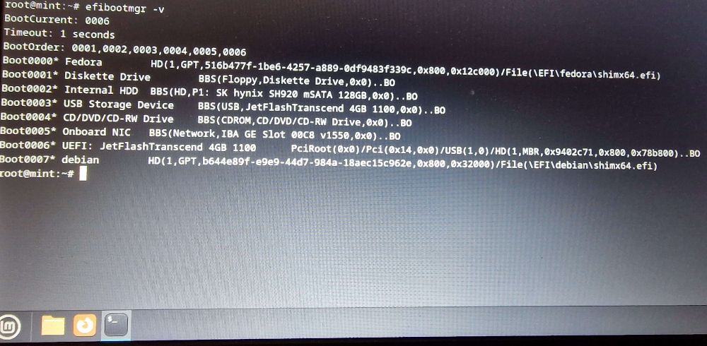 Photograph of the output of the efibootmgr -v command on the laptop. It shows:

BootCurrent: 0006
Timeout: 1 seconds
BootOrder: 0001,0002,0003,0004,0005,0006
Boot0000* Fedora HD(1,GPT,HD Reference)/File(\EFI\fedora\shimx64.efi)
Boot0001* Diskette Drive
Boot0002* Internal HDD
Boot0003* USB Storage Device
Boot0004* CD/DVD/CD-RW Drive
Boot0005* Onboard NIC
Boot0006* UEFI: JetFlashTranscend 4GB 1100
Boot0007* debian HD(1,GPT,HD Reference)/File(\EFI\debian\shimx64.efi)